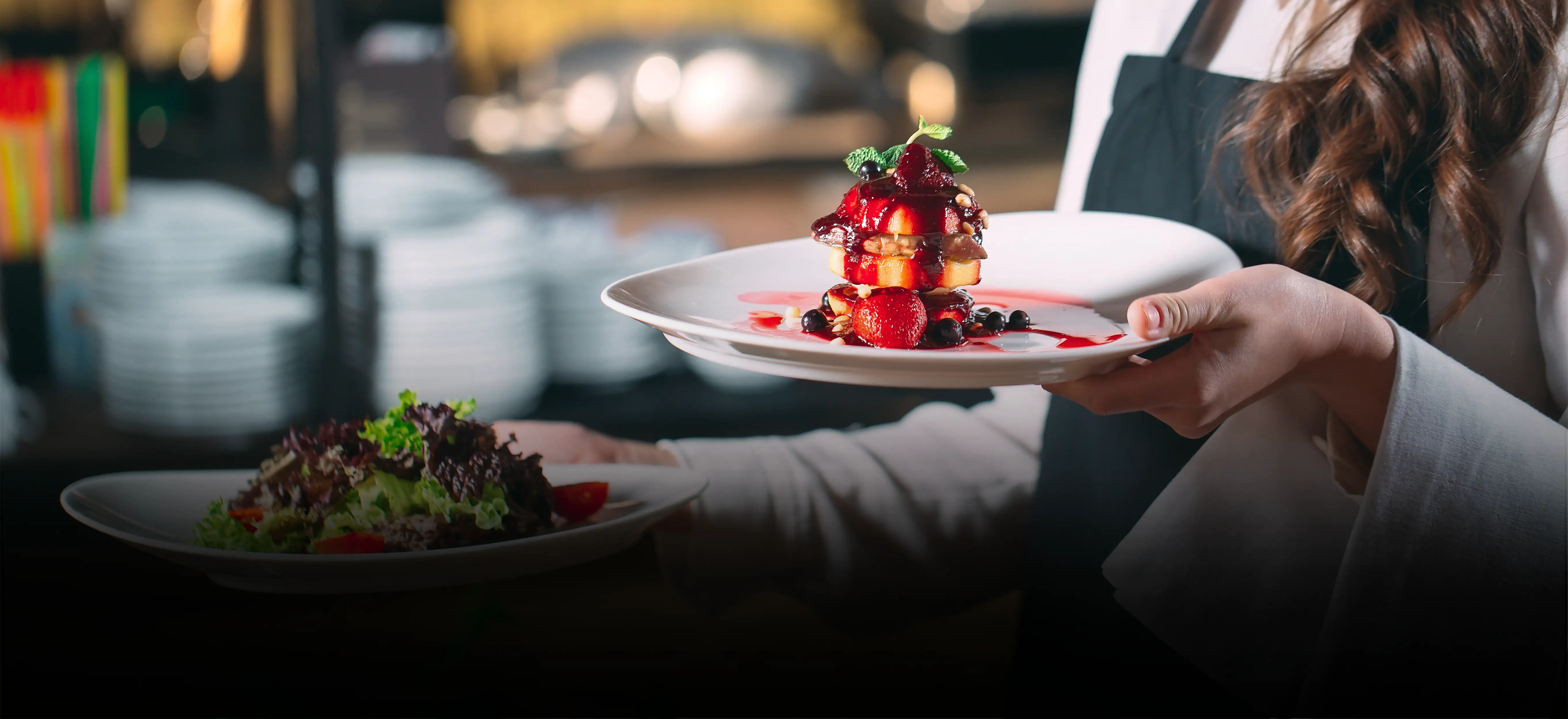 Kellner serviert Gerichte im Restaurant Tilia